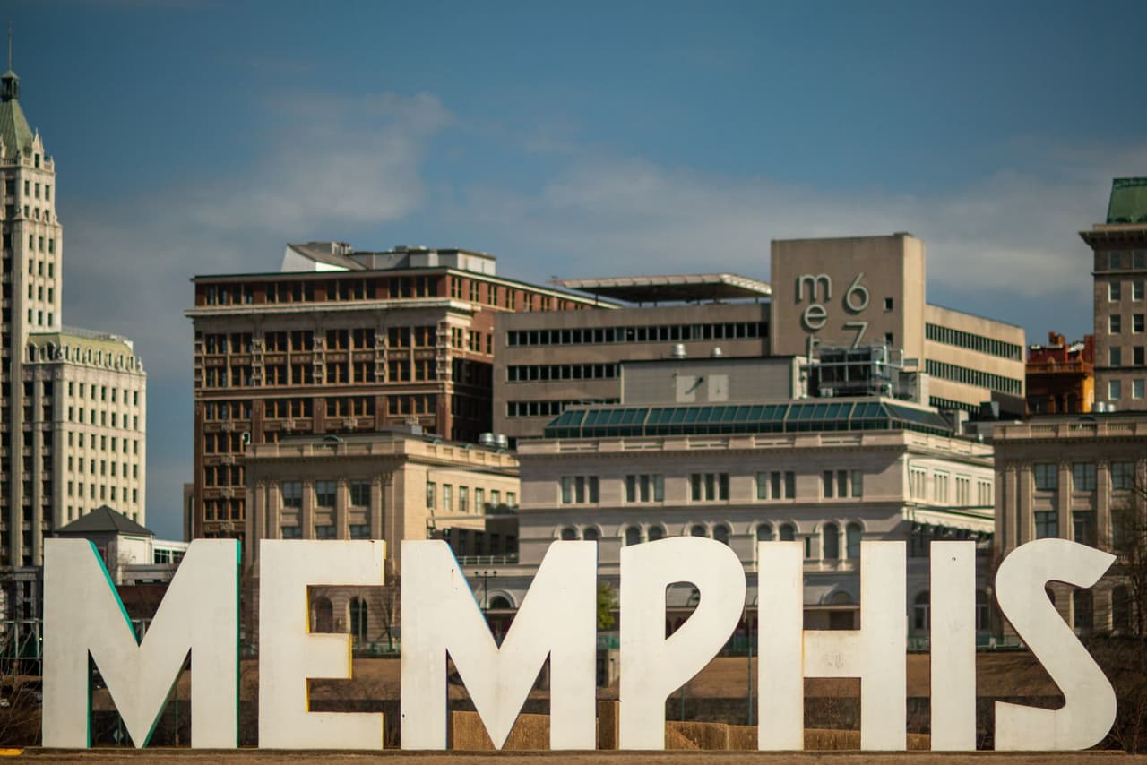 The Memphis sign with the downtown Memphis skyline